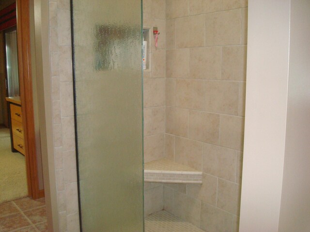 bathroom with a tile shower