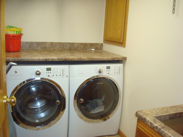 clothes washing area with separate washer and dryer