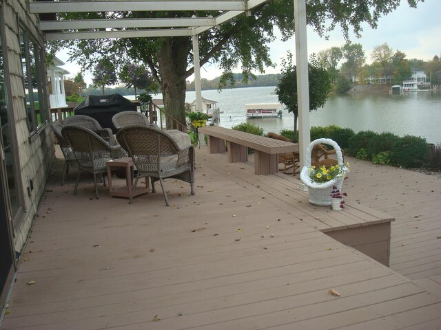 wooden terrace featuring a water view