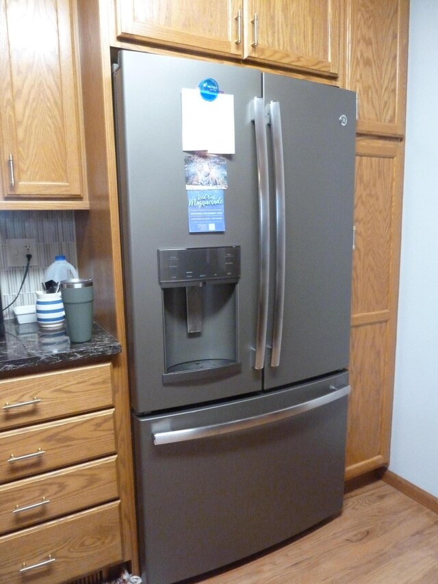 kitchen featuring stainless steel fridge and light hardwood / wood-style floors