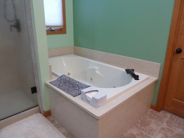 bathroom featuring plus walk in shower and tile patterned flooring