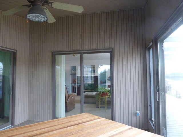 wooden terrace featuring ceiling fan