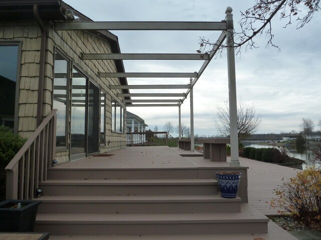 wooden deck featuring a water view