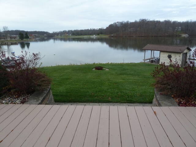 exterior space featuring a lawn and a water view