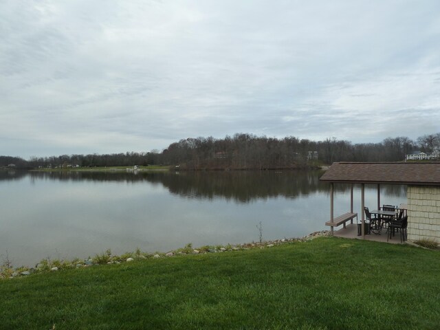 dock area with a lawn, a water view, and a patio