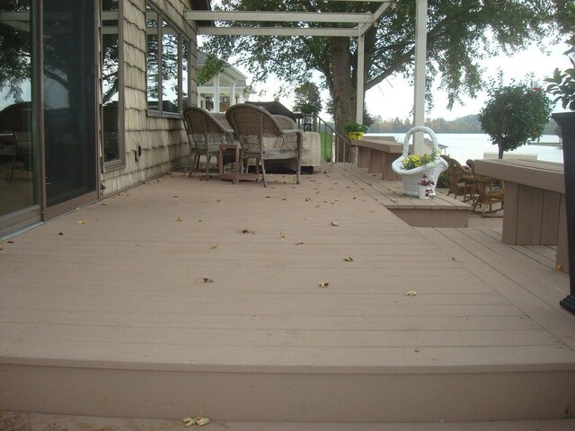 wooden terrace featuring a water view