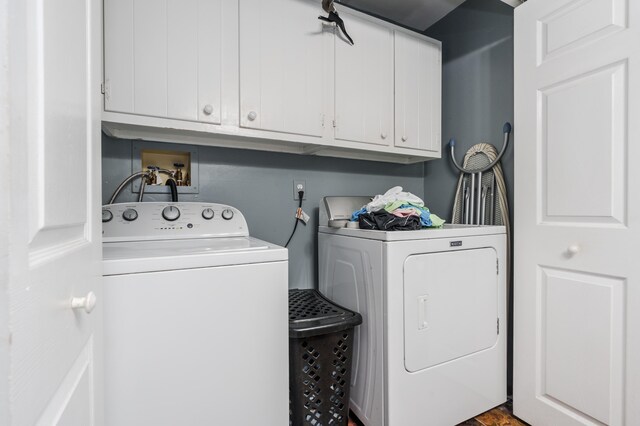 washroom with cabinets and washing machine and dryer