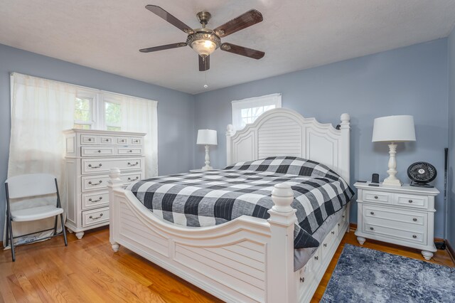 bedroom featuring light hardwood / wood-style floors and ceiling fan