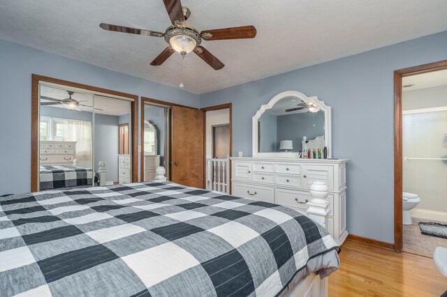 bedroom with ceiling fan, connected bathroom, and light hardwood / wood-style flooring