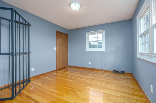 empty room with hardwood / wood-style floors