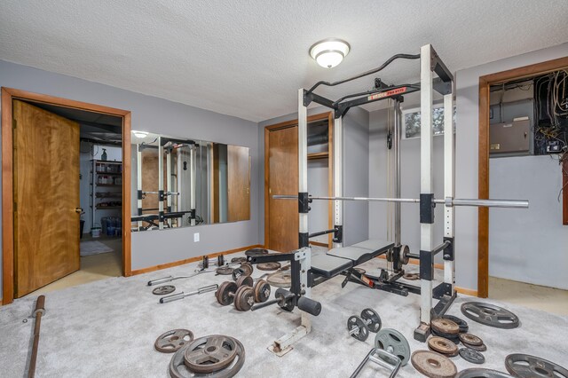 exercise room featuring a textured ceiling