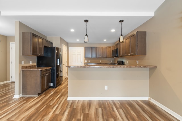 kitchen with kitchen peninsula, black range with electric cooktop, dark wood-type flooring, decorative light fixtures, and stainless steel fridge with ice dispenser