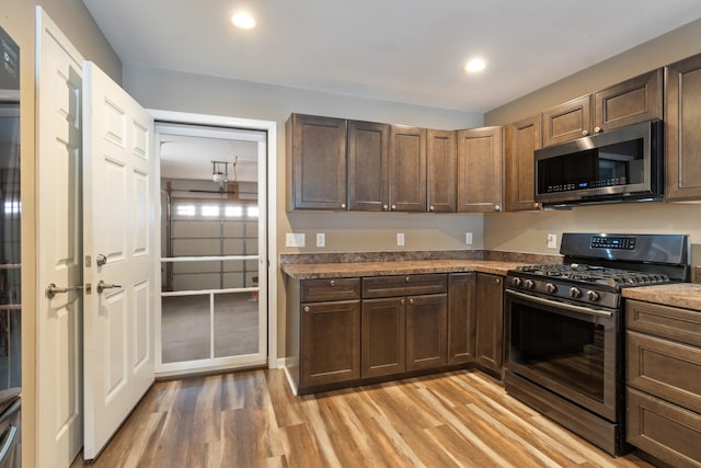 kitchen featuring light wood-type flooring and appliances with stainless steel finishes