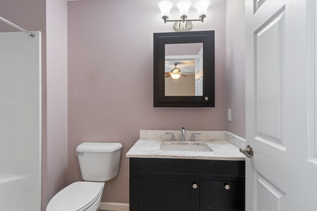 bathroom featuring ceiling fan, vanity, and toilet