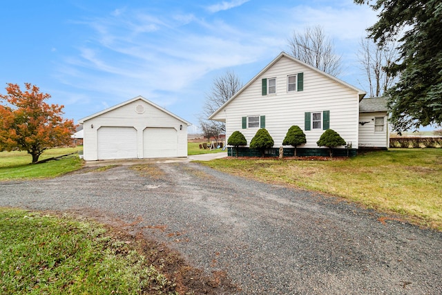 view of front facade featuring an outbuilding, a front lawn, and a garage