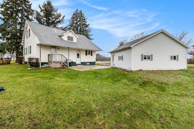 back of property featuring a yard and a patio