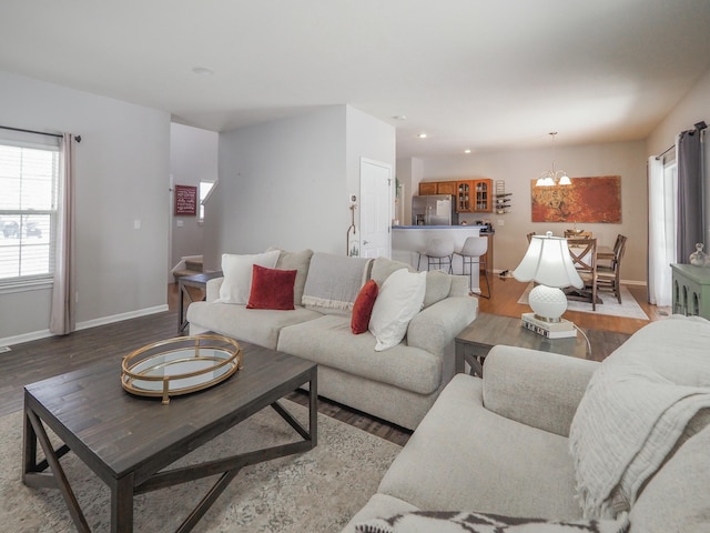 living room with wood-type flooring and a notable chandelier