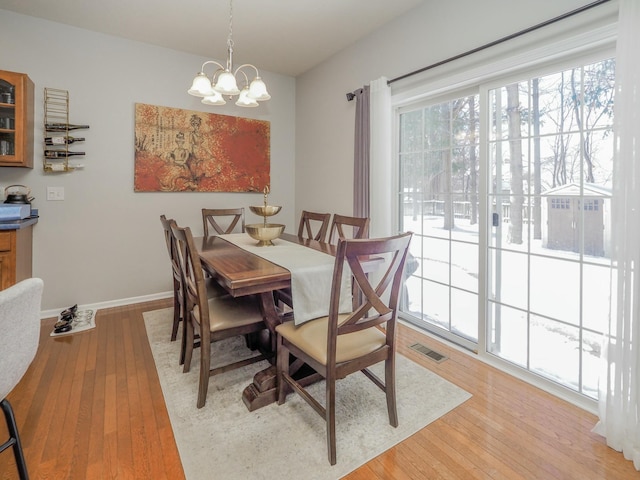 dining room featuring light hardwood / wood-style floors and an inviting chandelier