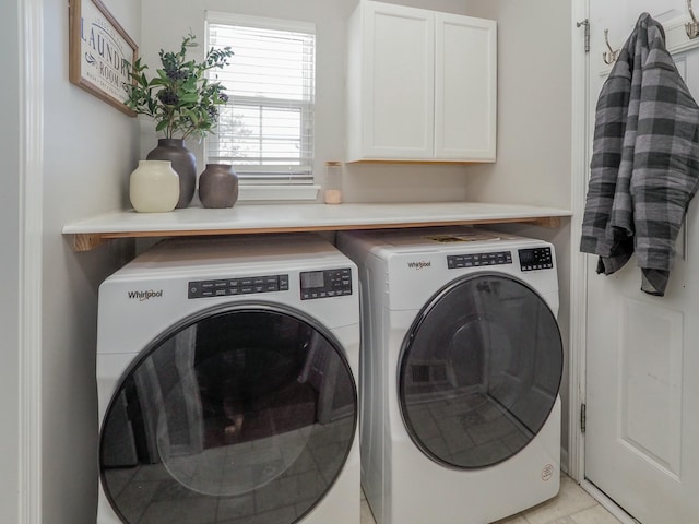 laundry room featuring cabinets and washing machine and clothes dryer