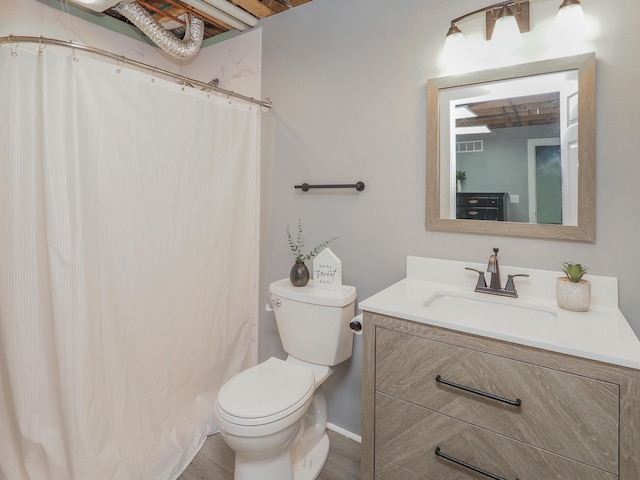 bathroom with a shower with shower curtain, hardwood / wood-style floors, vanity, and toilet