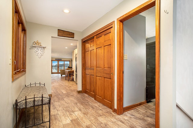 hall with light hardwood / wood-style floors