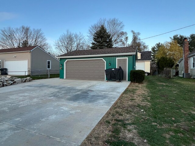 garage featuring a lawn and central air condition unit