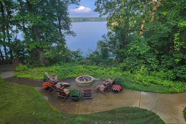 exterior space with a fire pit and a water view