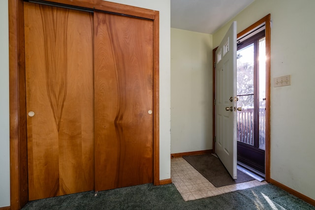 foyer entrance featuring light carpet