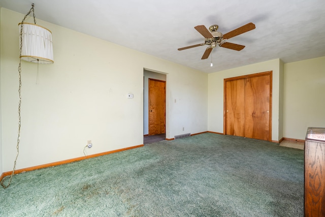 unfurnished bedroom featuring carpet, ceiling fan, and a closet