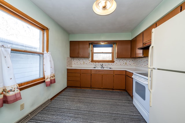 kitchen featuring backsplash, dark carpet, white appliances, and sink