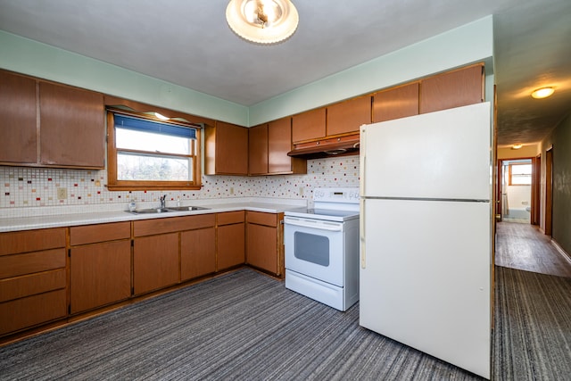 kitchen with plenty of natural light, decorative backsplash, white appliances, and sink