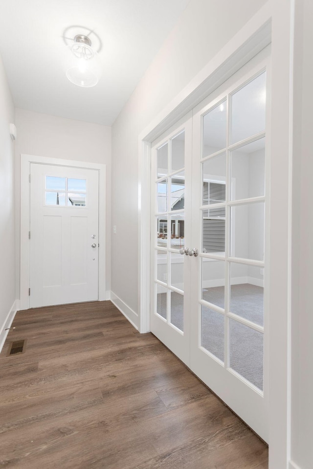 doorway with french doors and hardwood / wood-style flooring