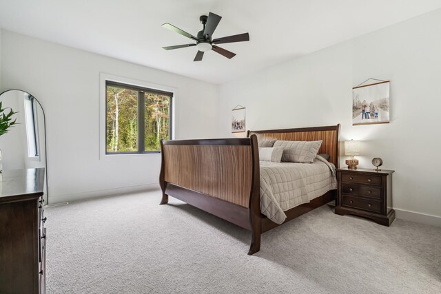 bedroom featuring ceiling fan and light carpet