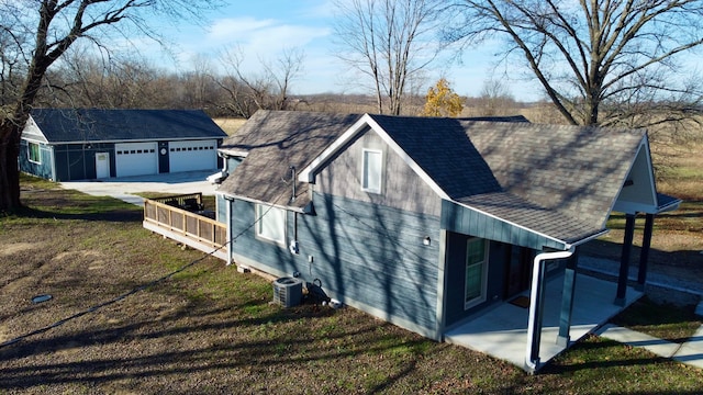 view of side of property featuring a patio area and cooling unit