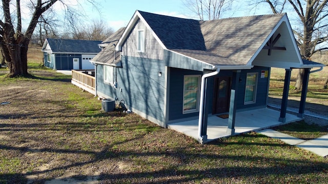 view of property exterior featuring a lawn, central AC, and a patio