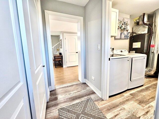 washroom featuring washer and clothes dryer and light wood-type flooring