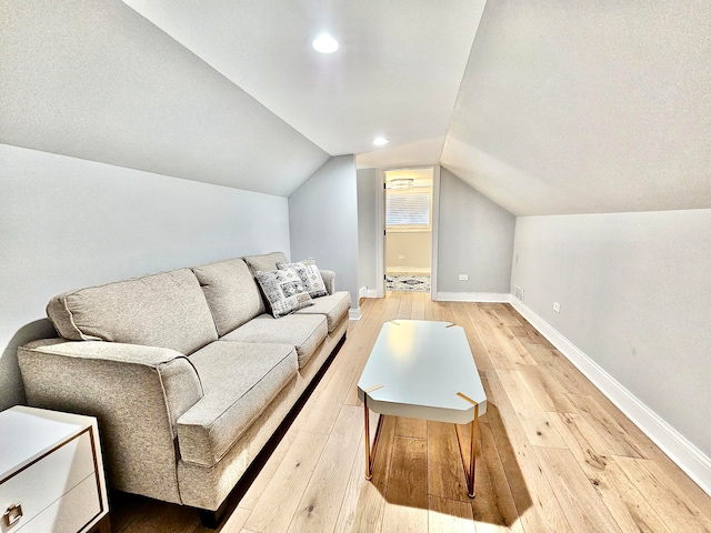 living room featuring hardwood / wood-style floors and lofted ceiling