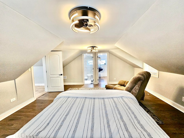 bedroom featuring wood-type flooring and vaulted ceiling