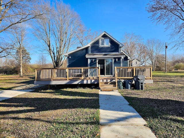 view of front of property with a wooden deck and a front lawn