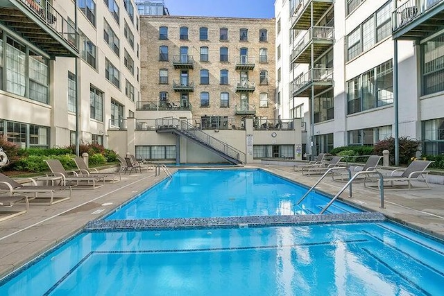 view of swimming pool featuring a patio area