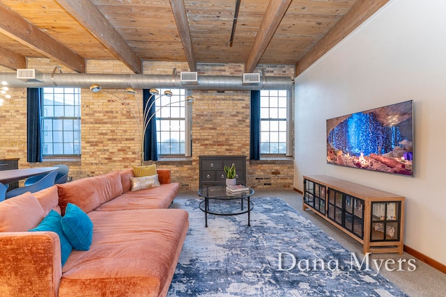 living room with beamed ceiling, wood ceiling, and brick wall