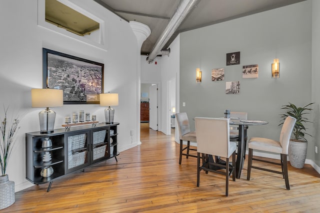 dining area with a high ceiling and light wood-type flooring