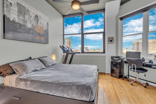 bedroom with ceiling fan and wood-type flooring