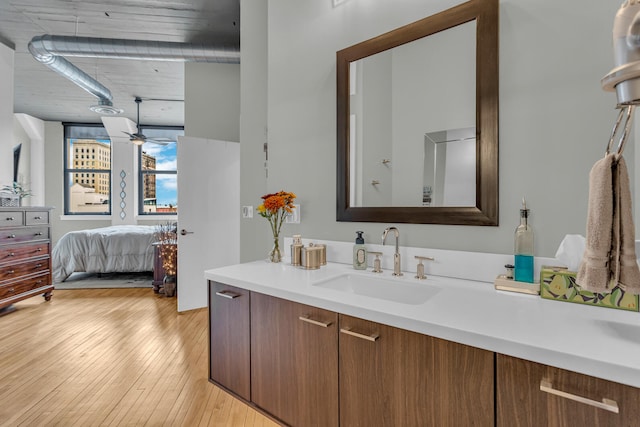 bathroom featuring ceiling fan, wood-type flooring, and vanity