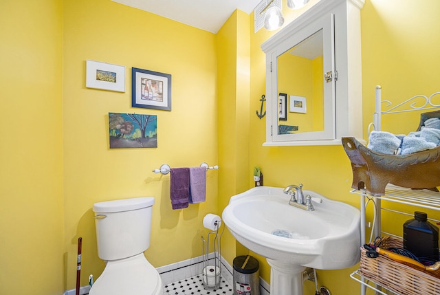 bathroom with sink, tile patterned flooring, and toilet