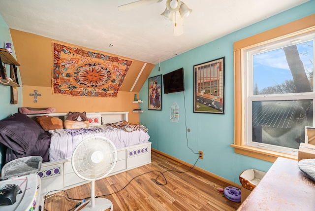 bedroom with hardwood / wood-style floors, ceiling fan, and lofted ceiling