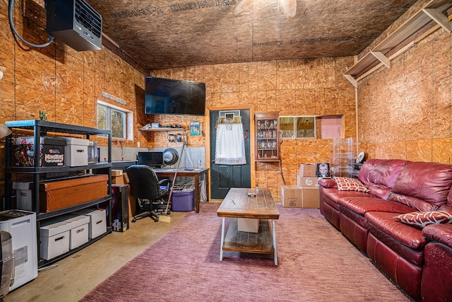 carpeted office featuring vaulted ceiling