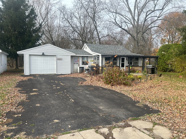 single story home featuring a porch and a garage