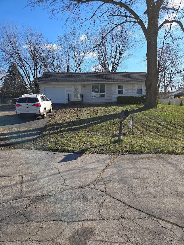 view of front of property with a garage and a front yard