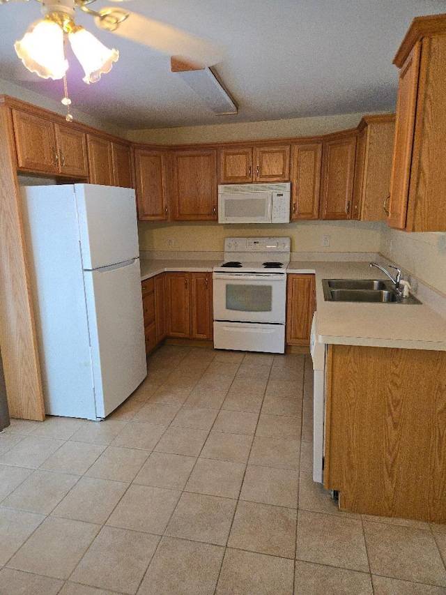 kitchen with light tile patterned floors, white appliances, ceiling fan, and sink